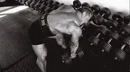 -Bodybuilder-John-Meadows-Lifting-Dumbbell-Rack-BW.webp