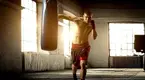 Young-Boxer-Punching-Heavy-Bag-In-Boxing-Gym.webp