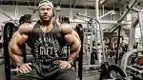 Phil-Heath-Sitting-On-Bench-Serious.webp