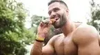 Happy-Muscular-Man-Eating-Protein-Bar.webp