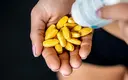 athlete-pouring-pills-into-palms.webp