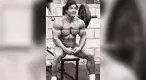 bu-sitting-on-a-barbell-bench-at-World-Gym-in-1981.webp