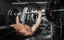 muscular-man-doing-bench-press.webp