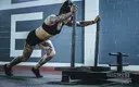 fit-female-doing-sled-pushes.webp