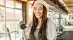 Doing-A-Dumbbell-Workout-While-Wearing-A-Santa-Hat.webp