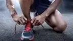 Male-With-Veiny-Arms-Tying-Running-Shoes.webp