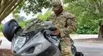 edric-McMillan-in-his-army-uniform-on-a-motorcycle.webp