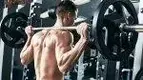 h-Machine-With-Barbell-On-His-Back-Ready-For-Squat.webp