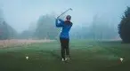 r-wearing-a-track-suit-playing-golf-on-a-foggy-day.webp