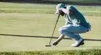 Golfer-setting-up-the-lie-on-the-green.webp