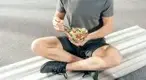 Man-Sitting-On-Bench-Eating-Salad.webp