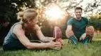 Healthy-Happy-Couple-Stretching-Grass.webp