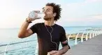 Black-Male-Runner-Drinking-Water-After-Running.webp