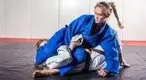 rforming-a-brazilian-jiujitsu-move-on-her-opponent.webp