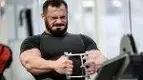 Muscular-Man-With-Beard-Straining-To-Lift-Weights.webp