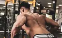 shirtless_muscular_man_doing_a_back_exercise.webp