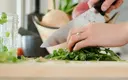 close_up_of_hand_chopping_cilantro.webp