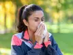 -blowing-her-nose-as-she-is-working-out-while-sick.webp