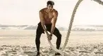 Fit-Man-Working-Out-On-The-Beach-With-Battle-Ropes.webp