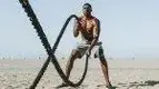 Guy-On-Beach-Battle-Ropes.webp