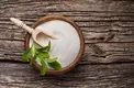 Stevia leaf with sugar in wooden bowl on wooden table