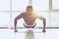 A man does pushups as part of a calisthenics workout