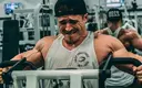 Close up of muscular man doing machine rows in the gym