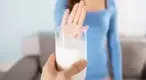 Woman-Rejecting-Glass-Of-Milk