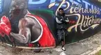 Boxer Richardson Hitching leaning on a street mural of him