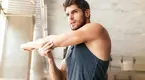 Man-Stretching-Arm-In-Sunny-Room to boost your mental health