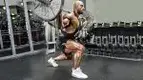 Professional bodybuilder Juan Morel performing a barbell lunge stance squat exercise