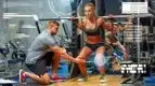 A personal trainer showing a fit woman her the mistakes of her squatting form and showing how to fix her bad squat form