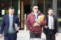 three men, two of them legal officers, leaving court