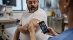 Doctor taking an overweight patient vitals using a smart phone