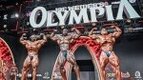 Hadi Choopan, Derek Lunsford, and Samson Duada on the 2024 Olympia Stage competing for the 2024 Mr. Olympia Title