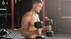 Muscular man doing arm exercises with a hammer curl