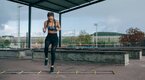 Fit and athletic woman improving her athleticism using a agility ladder workout