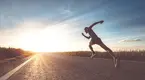 Man-Sprinting-Into-Sunset-Empty-Road.webp