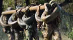 Navy-Seal-Training-Holding-Log-Muddy.webp