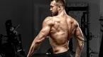 Muscular--Man-Back-Posing-Gym.webp