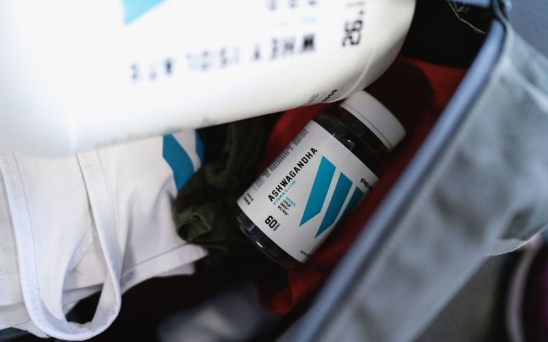 Close up shot of Swolverine's Ashwagandha bottle in a gym bag