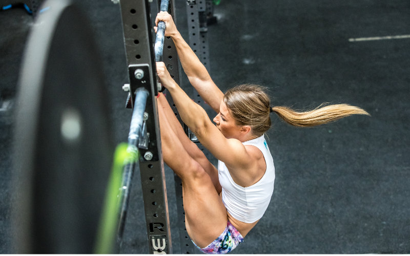 Swolverine athlete doing toes to bar.